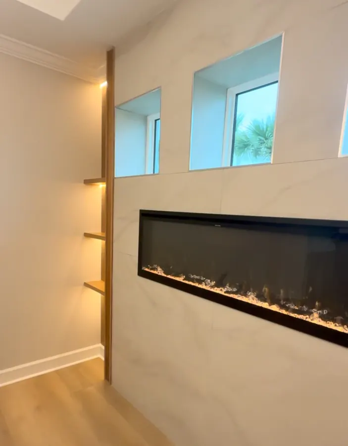 Porcelain tile fireplace wall with white oak shelves