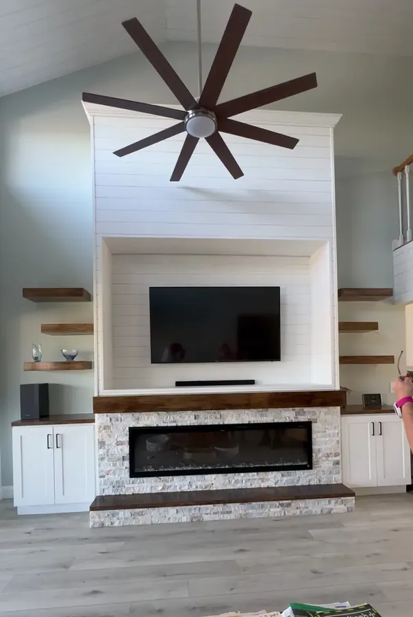 White shiplap fireplace wall with floating shelves